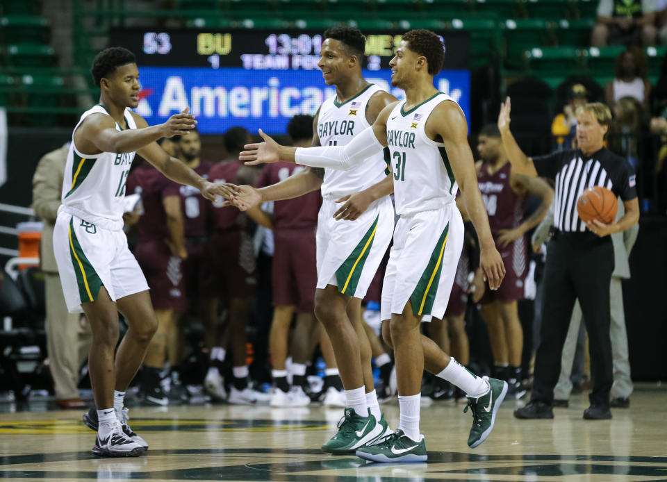 Baylor Bears guard Jared Butler (12) greets Mark Vital (11) and MaCio Teague (31) on the court during a game on Dec. 3, 2019. (Ray Carlin-USA TODAY Sports)