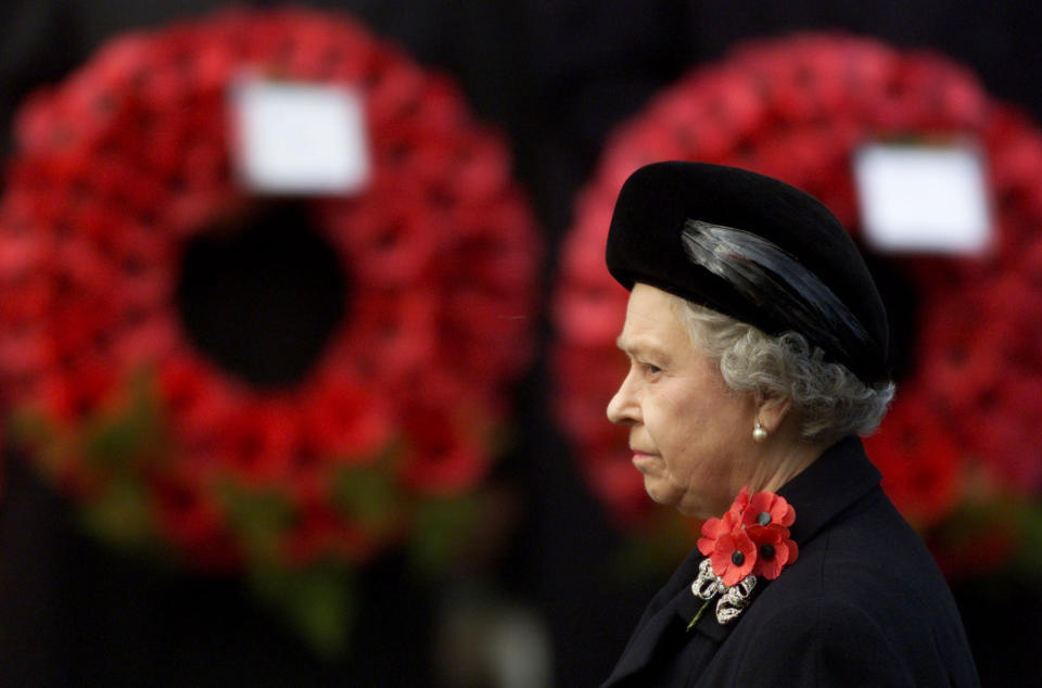 <p>The Queen stands for the two minutes silence in front of wreaths of poppies during the Remembrance Sunday parade at the Cenotaph in central London on 12 November 2000. (PA)</p> 