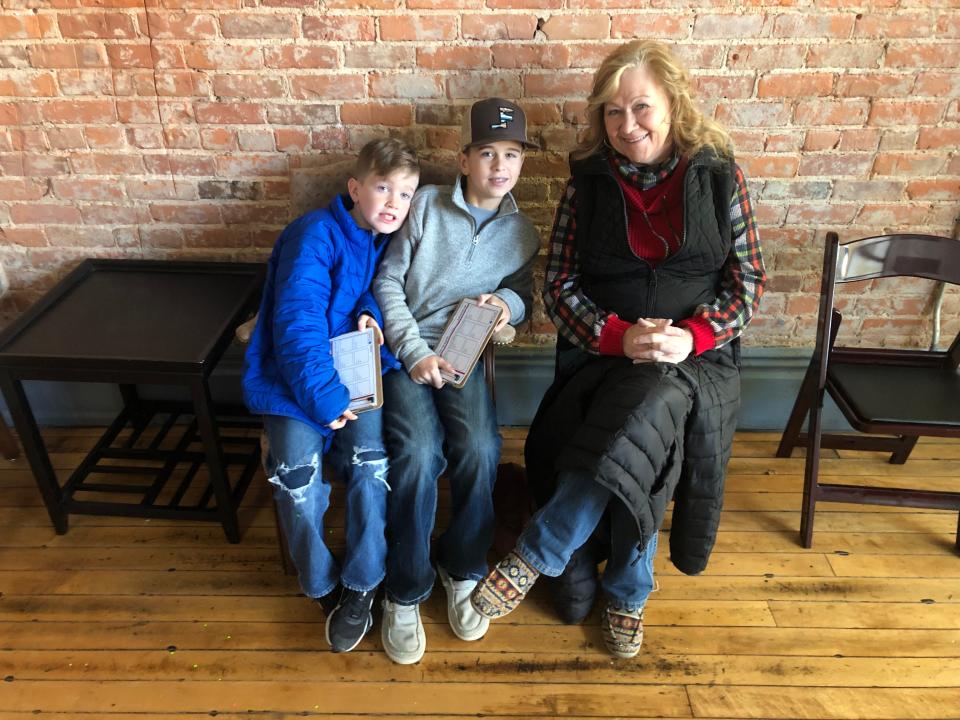 Luke Boley, 9, Cash Gaus, 13, and grandmother Cheryl Smith get ready to look for holiday gifts at the Tiny Tim Shoppe on Saturday.