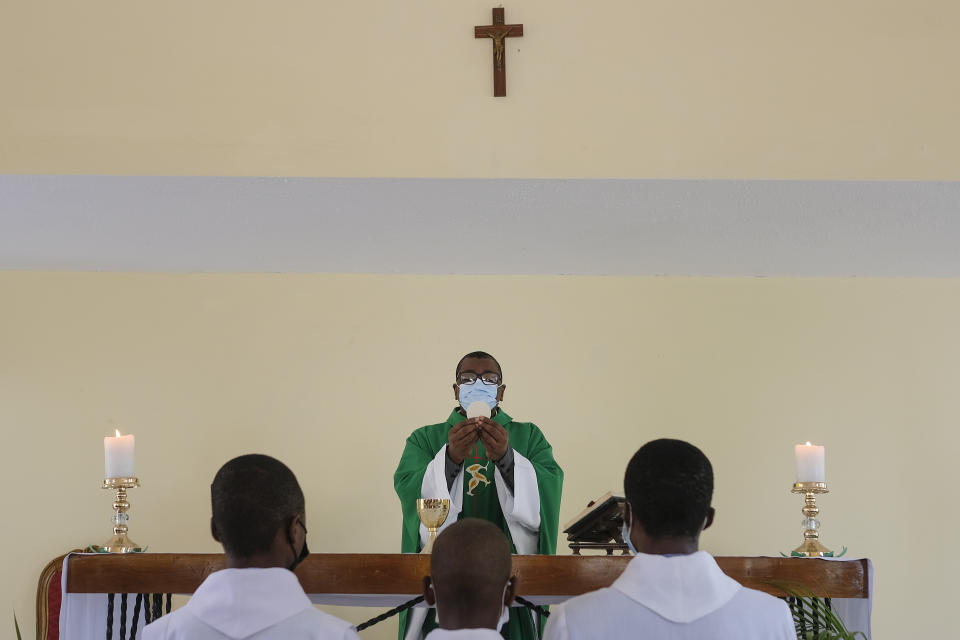FILE - Catholic priest Jean-Nicaisse Milien celebrates Mass in Port-au-Prince, Haiti, Sunday, Nov. 7, 2021. Father Milien was kidnapped for 20 days along with other priests, nuns, and civilians in April by the 400 Mawozo gang who have been holding 17 members of a U.S.-based missionary group Christian Aid Ministries for more than 3 weeks. (AP Photo/Matias Delacroix, File)