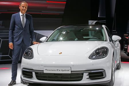 Porsche CEO Oliver Blume poses near a Porsche Panamera 4 E-Hybrid during a news conference on media day at the Mondial de l'Automobile, the Paris auto show, in Paris, France, September 29, 2016. REUTERS/Jacky Naegelen