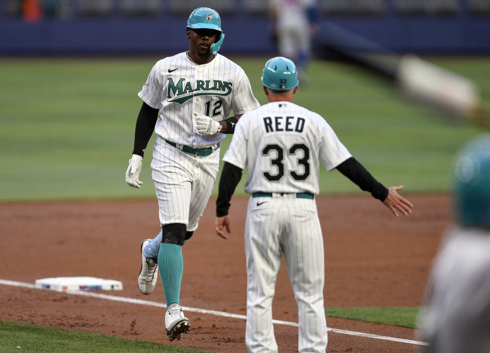 Miami Marlins' Jorge Soler (12) runs toward home plate after hitting a home run during the second inning of a baseball game against the New York Mets, Friday, March 31, 2023, in Miami. (AP Photo/Michael Laughlin)