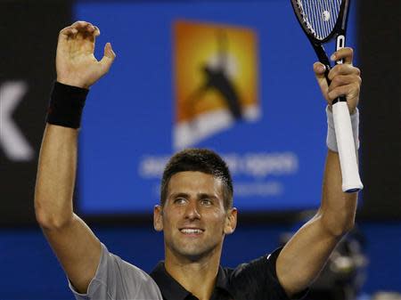 Novak Djokovic of Serbia celebrates defeating Lukas Lacko of Slovakia in their men's singles match at the Australian Open 2014 tennis tournament in Melbourne January 13, 2014. REUTERS/David Gray