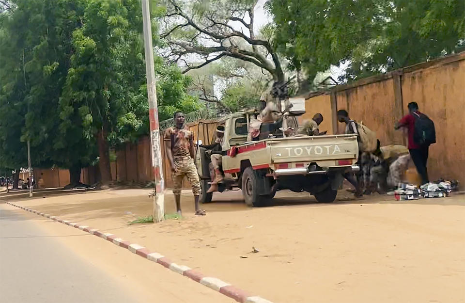 In this image made from video, soldiers stand in the streets of Niamey, Niger, Friday, July 28, 2023. The general who led a coup in Niger defended the takeover on state television and asked for support from the nation and international partners, as concerns grew that the political crisis could set back the country's fight against jihadists and increase Russia's influence in West Africa. (AP Photo)