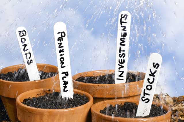Flower pots being watered with investment labels.