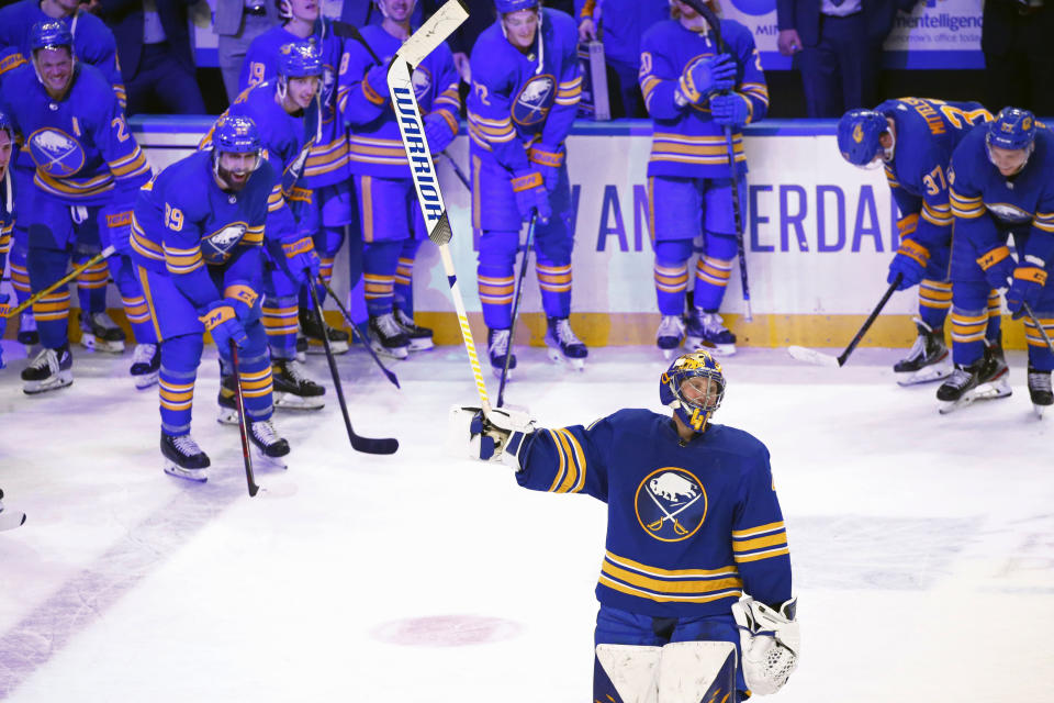 Buffalo Sabres goaltender Craig Anderson, froeground, celebrates his 300th career victory following the third period of an NHL hockey game against the Vegas Golden Knights, Thursday, March 10, 2022, in Buffalo, N.Y. (AP Photo/Jeffrey T. Barnes)