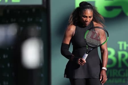 Mar 21, 2018; Key Biscayne, FL, USA; Serena Williams of the United States looks at her racket after missing a shot against Naomi Osaka of Japan (not pictured) on day two of the Miami Open at Tennis Center at Crandon Park. Osaka won 6-3, 6-2. Mandatory Credit: Geoff Burke-USA TODAY Sports