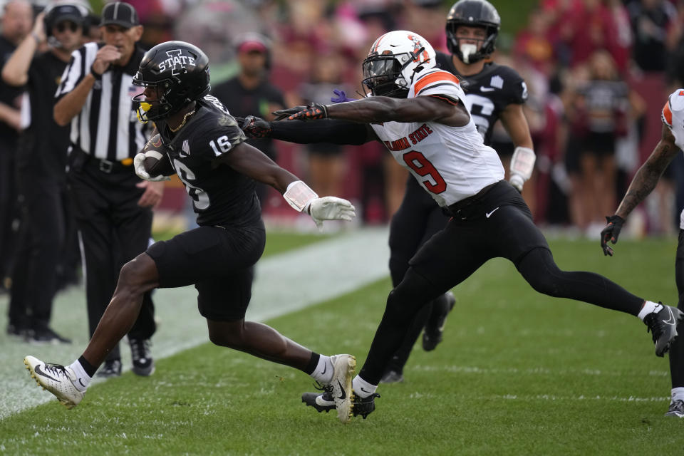 Iowa State wide receiver Daniel Jackson (16) is pushed out of bounds by Oklahoma State safety Trey Rucker (9) after catching a pass during the first half of an NCAA college football game, Saturday, Sept. 23, 2023, in Ames, Iowa. (AP Photo/Charlie Neibergall)