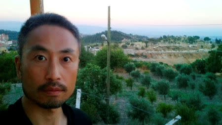 Japanese journalist Jumpei Yasuda, who is seen in this photo sent by e-mail to a Kyodo News photographer on June 23, 2015 before Yasuda's departure to Syria, with the message reading, "I will smuggle myself into Syria from now", is seen in this undated photo released by Kyodo on December 24, 2015. Kyodo/via REUTERS/Files