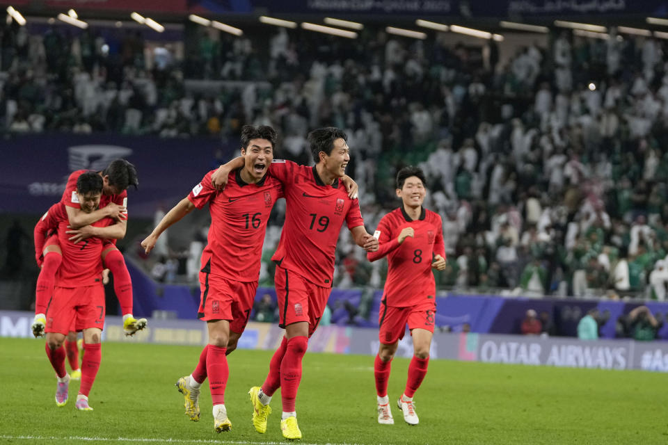 South Korea's players celebrate after the winning penalty in a penalty shootout at the end of the Asian Cup Round of 16 soccer match between Saudi Arabia and South Korea, at the Education City Stadium in Al Rayyan, Qatar, Tuesday, Jan. 30, 2024. (AP Photo/Thanassis Stavrakis)