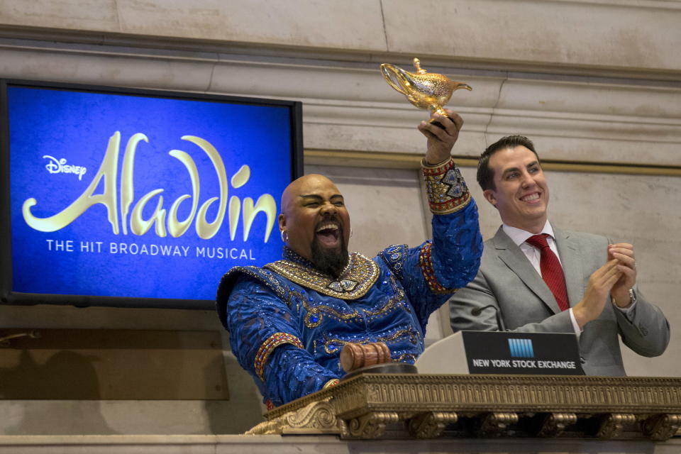 Actor James Monroe Iglehart, (L) who plays the character of Genie in Disney’s 'Aladdin' on Broadway, shows his magic lamp as he rings the opening bell at the New York Stock Exchange October 29, 2015. REUTERS/Brendan McDermid