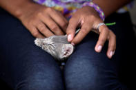 A Honduran migrant teenager pets a cat at the Senda de Vida migrant shelter in Reynosa, in Tamaulipas state, Mexico June 22, 2018. Picture taken June 22, 2018. REUTERS/Daniel Becerril