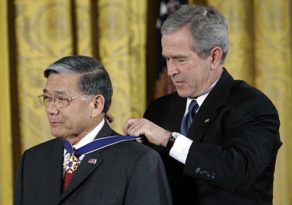 FILE - President Bush, right, bestows the Presidential Medal of Freedom to former Transportation Secretary Norman Y. Mineta during a ceremony in the East Room of the White House in Washington, Friday, Dec. 15, 2006. Mineta, who broke racial barriers for Asian Americans serving in high-profile government posts and ordered commercial flights grounded after the 9/11 terror attacks as the nation's federal transportation secretary, died Tuesday, May 3, 2022. He was 90. (AP Photo/Pablo Martinez Monsivais, File)