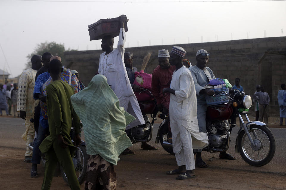 Parents are reunited with their daughters in Jangabe, Nigeria, Wednesday, March 3, 2021. More than 300 schoolgirls kidnapped last week in an attack on their school in northwest Nigeria have arrived in Jangabe after been freed on Tuesday. The Girls were abducted few days ago from Government Girls Secondary School in Jangabe in Zamfara state (AP Photo/Sunday Alamba)