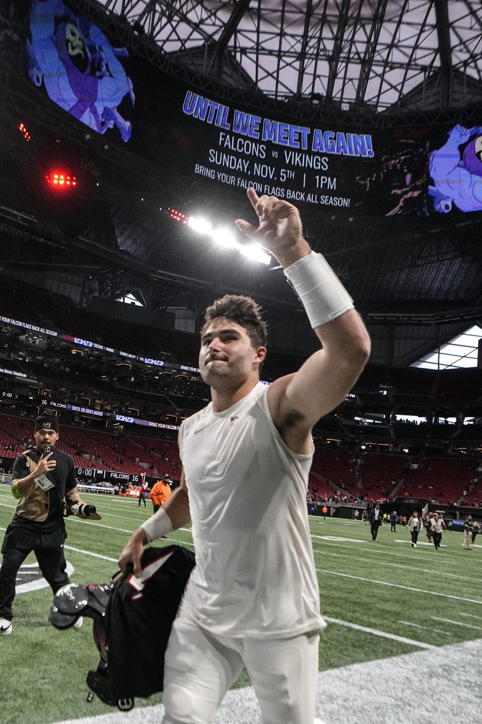 Washington Commanders quarterback Sam Howell (14) runs off the field after an NFL football game against the Atlanta Falcons, Sunday, Oct. 15, 2023, in Atlanta. Washington Commanders won 24-16. (AP Photo/John Bazemore)