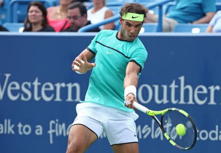 Aug 17, 2016; Mason, OH, USA; Rafael Nadal (ESP) returns a shot against Pablo Cuevas (URU) on day five during the Western and Southern tennis tournament at Linder Family Tennis Center. Aaron Doster-USA TODAY Sports