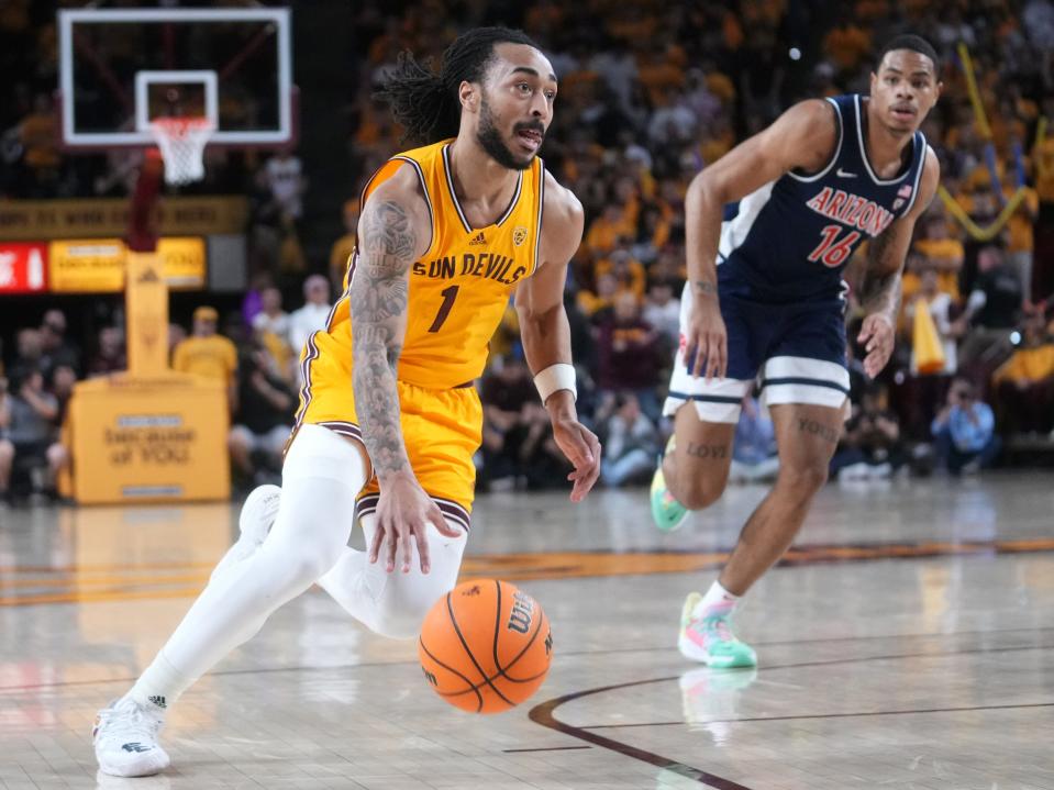ASU Sun Devils guard Frankie Collins (1) drives past UA Wildcats forward Keshad Johnson (16) at Desert Financial Arena in Tempe on Feb. 28, 2024.