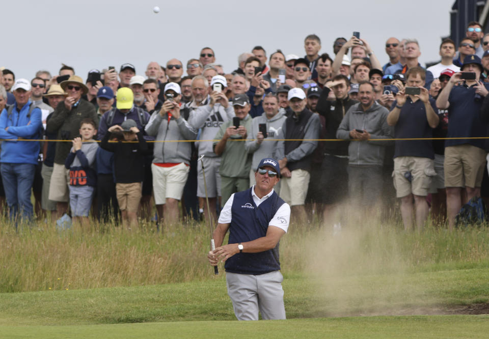 United States' Phil Mickelson plays out of a bunker on the 1st hole during the second round of the British Open Golf Championship at Royal St George's golf course Sandwich, England, Friday, July 16, 2021. (AP Photo/Ian Walton)