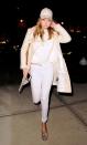 <p>The model steps out in an all-white ensemble, complete with a midi coat and a leather baseball hat. </p>