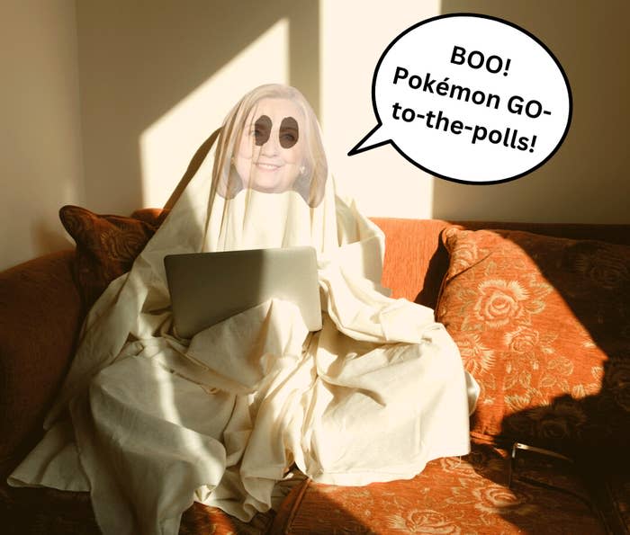 a bedsheet with hilary clinton's face draped over someone sitting on a couch using their laptop with a speech bubble that says, "Boo! Pokemon Go-to-the-polls!"