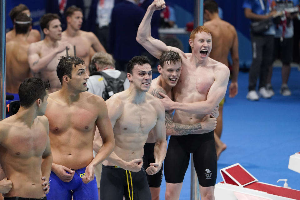 Britain celebrates after winning the mens' 4x200-meter freestyle relay at the 2020 Summer Olympics, Wednesday, July 28, 2021, in Tokyo, Japan. (AP Photo/Charlie Riedel)