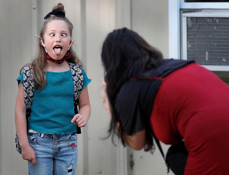 Margaux Birch, 8, makes a goofy face for a photo by her mom, Cassie, in the schoolyard on the first day of school in Rockland on Monday, Aug. 30, 2021.