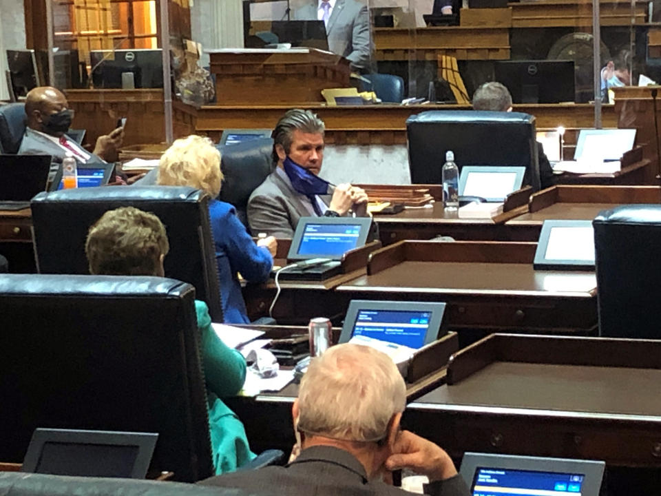 Indiana Senate Appropriations Committee Chairman Ryan Mishler, center speaks with a fellow senator during an April 1, 2021, Senate session at the Indiana Statehouse in Indianapolis. Mishler's committee dedicated $75 million from the state's federal COVID-19 relief funding toward a new program helping workers obtain short-term training certifications despite the concept receiving little public discussion and few details on the money would be spent. (AP Photo/Tom Davies)