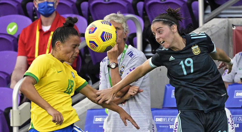 Brazil defender Camila (18) and Argentina forward Mariana Larroquette (19) battle for a header during the second half of a SheBelieves Cup women's soccer match, Thursday, Feb. 18, 2021, in Orlando, Fla. (AP Photo/Phelan M. Ebenhack)