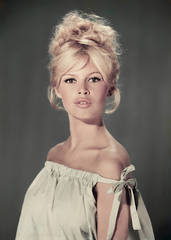 circa 1960: Studio portrait of actor and model Brigitte Bardot wearing a light blue off-the-shoulder dress. (Photo by Hulton Archive/Getty Images)