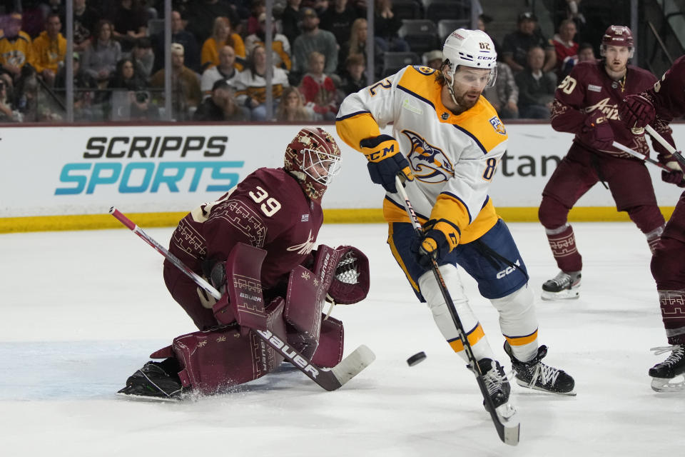Nashville Predators center Tommy Novak tries to score on Arizona Coyotes goaltender Connor Ingram (39) during the second period of an NHL hockey game Thursday, March 28, 2024, in Tempe, Ariz. (AP Photo/Rick Scuteri)