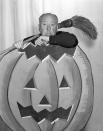 <p>The filmmaker posed with a giant pumpkin and broom in a promotional shot for <em>Alfred Hitchcock Presents</em>. </p>