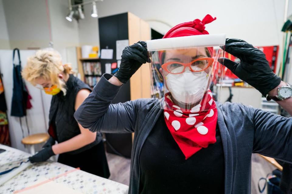 Sydney Palmer (left) and Jeanne Henzel-Swartz assemble disposable face shields at Joona Fabriculture in Alameda.