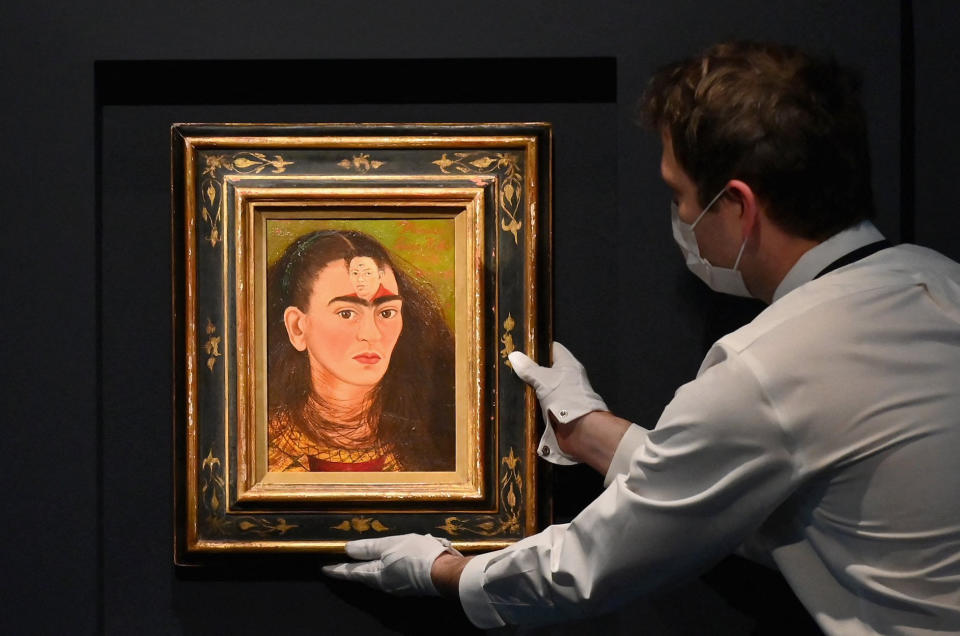 Image: An art handler adjusts Frida Kahlo's final 