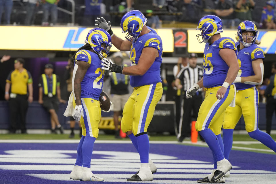 Los Angeles Rams running back Darrell Henderson Jr., left, celebrates with teammates after scoring a touchdown during the second half of an NFL football game against the Seattle Seahawks Sunday, Nov. 19, 2023, in Inglewood, Calif. (AP Photo/Mark J. Terrill)