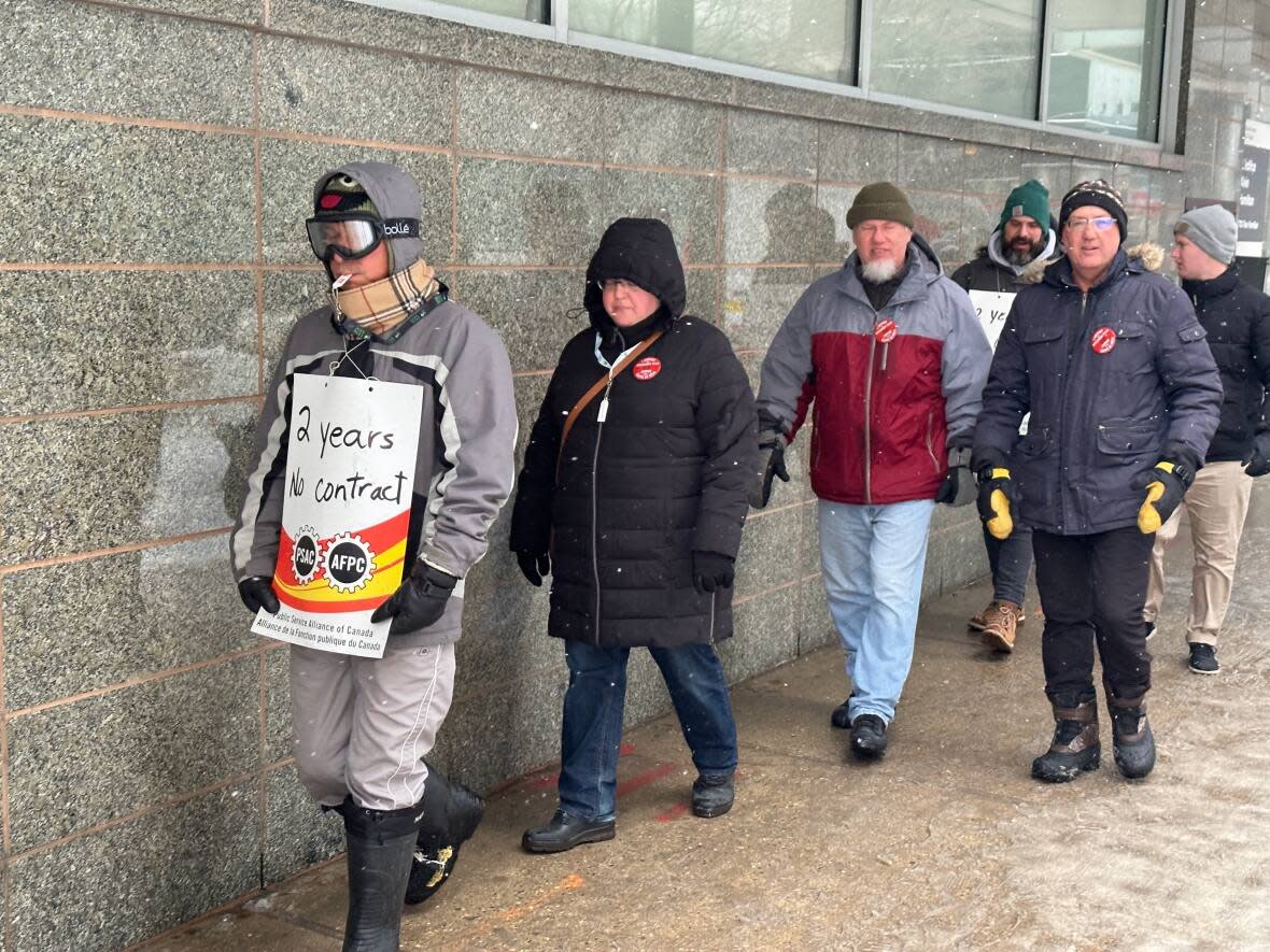 PSAC members in Regina picketed in wild weather Thursday for a better collective agreement with the Canadian government.  (Kirk Fraser/CBC - image credit)