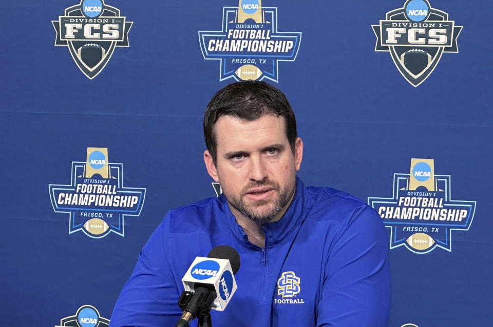 South Dakota State first-year coach Jimmy Rogers talks to the media Friday, Jan. 5, 2024, in Frisco, Texas, in advance of the NCAA Football Championship Subdivision title game. Top-seeded and undefeated SDSU has won 28 games in a row. Rogers, a former Jackrabbits player, was their defensive coordinator last year when they won their first FCS title in veteran coach John Stiegelmeier’s final game. South Dakota State plays against Montana on Sunday. (AP Photo/Stephen Hawkins)