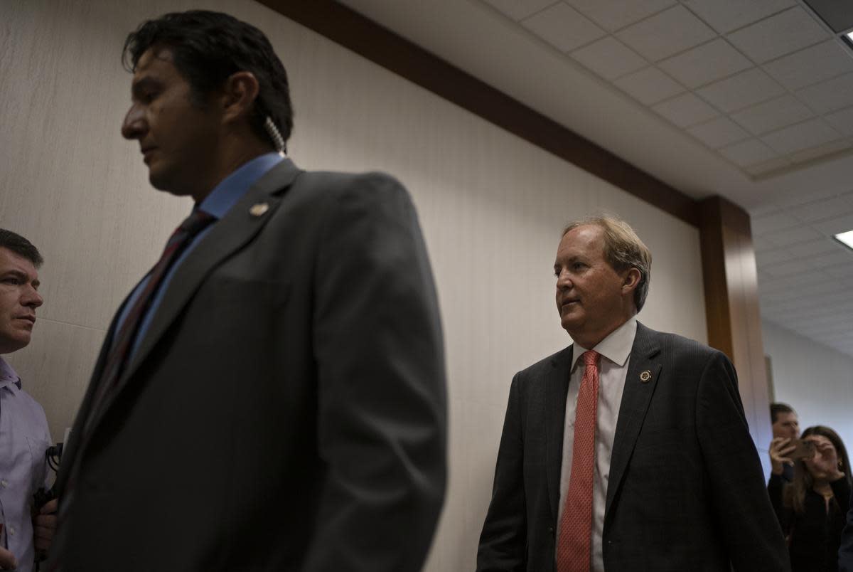 Texas Attorney General Ken Paxton enters the 185th Criminal District court at the Harris County Criminal Justice Center for his pretrial hearing March 26, 2024, in Houston.