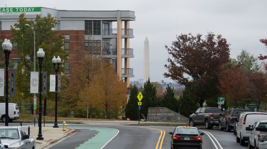 <em>The Washington Monument is seen in the background behind a new apartment building in Crystal City, Arlington, Va.</em> (AP Photo/Cliff Owen)