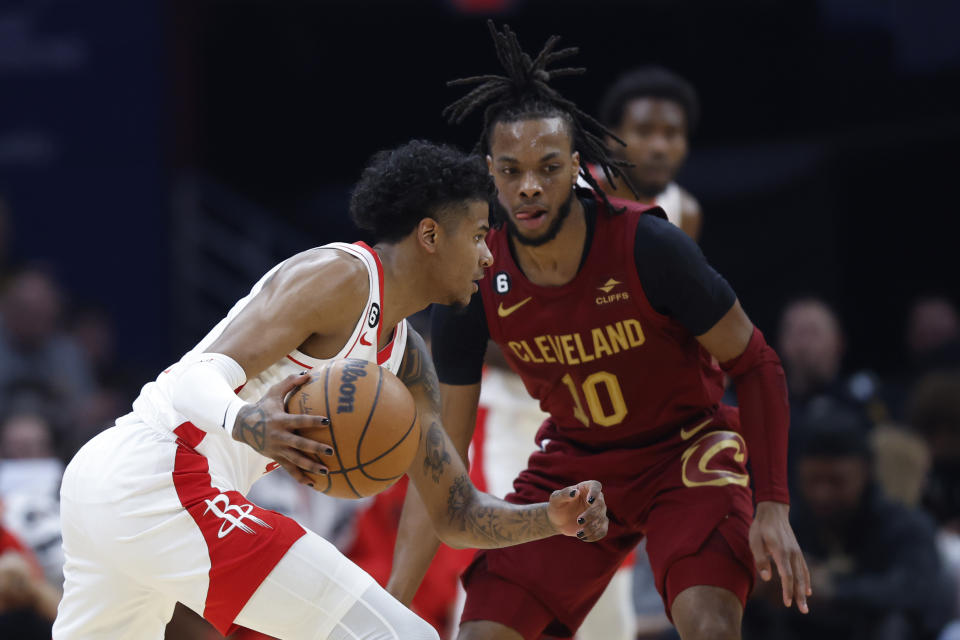 Houston Rockets guard Jalen Green, left, drives against Cleveland Cavaliers guard Darius Garland (10) during the first half of an NBA basketball game, Sunday, March 26, 2023, in Cleveland. (AP Photo/Ron Schwane)