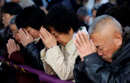 Believers take part in a weekend mass at an underground Catholic church in Tianjin November 10, 2013. REUTERS/Kim Kyung-Hoon/File Photo