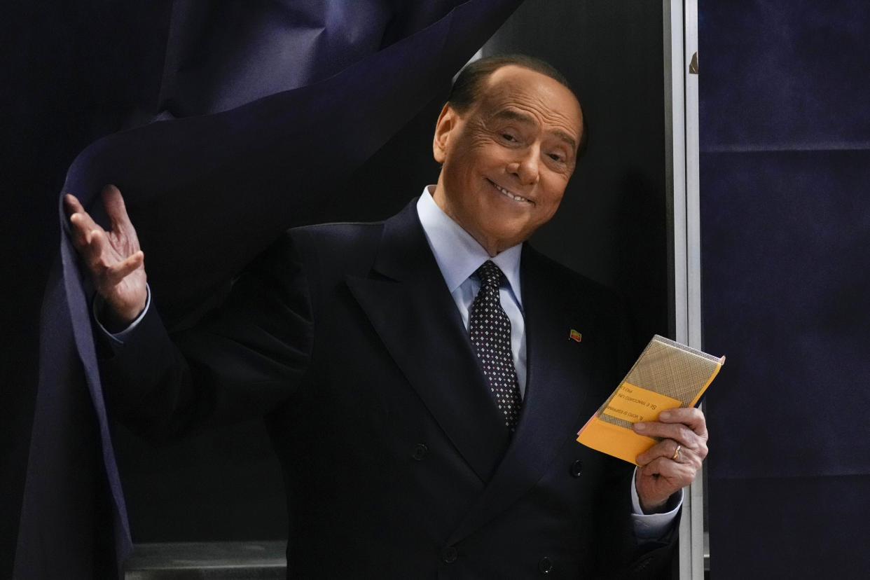 Silvio Berlusconi, leader of center-right, populist Forza Italia comes out of a voting booth before casting his ballot at a polling station in Milan, Italy, Sunday, Sept. 25, 2022. Just in time to celebrate his 86th birthday, Italy’s former premier Silvio Berlusconi is making his return to Italy's parliament, winning a seat in the Senate nearly a decade after being banned from public office over a tax fraud conviction. (AP Photo/Antonio Calanni, File )