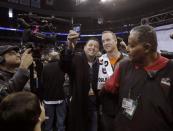 Denver Broncos quarterback Peyton Manning poses for a picture as he departs during Media Day for Super Bowl XLVIII at the Prudential Center in Newark, New Jersey January 28, 2014. REUTERS/Carlo Allegri