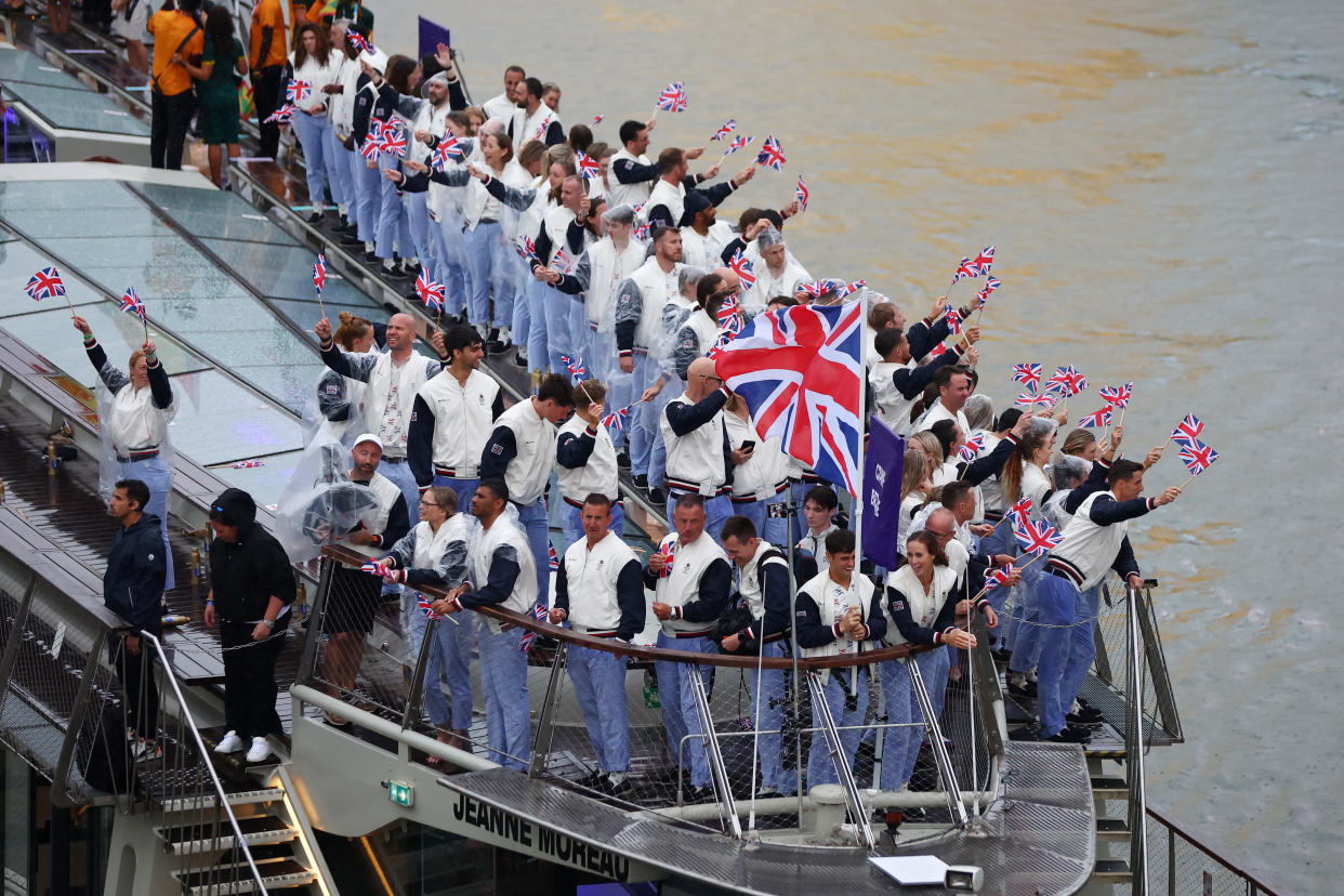 Thomas Daley and Helen Glover, Flagbearers of Team Great Britain, wave the flag on the athletes' parade team boat along the River Seine during the opening ceremony of the Olympic Games Paris 2024 on July 26, 2024 in Paris, France. (Photo by Maddie Meyer/Getty Images)