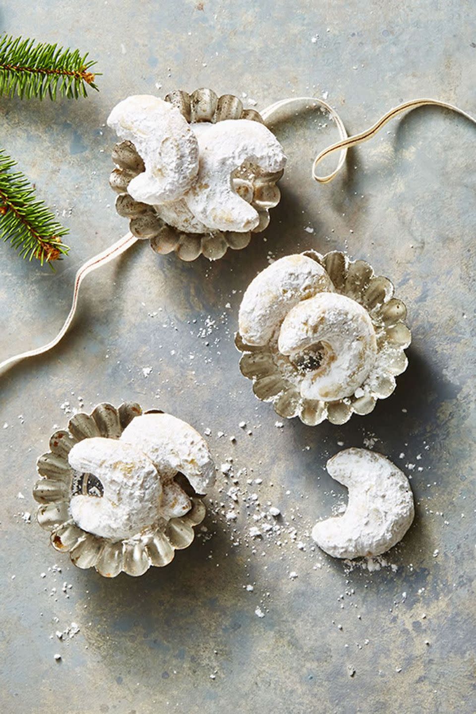 walnut crescent cookies with powdered sugar dusted on top