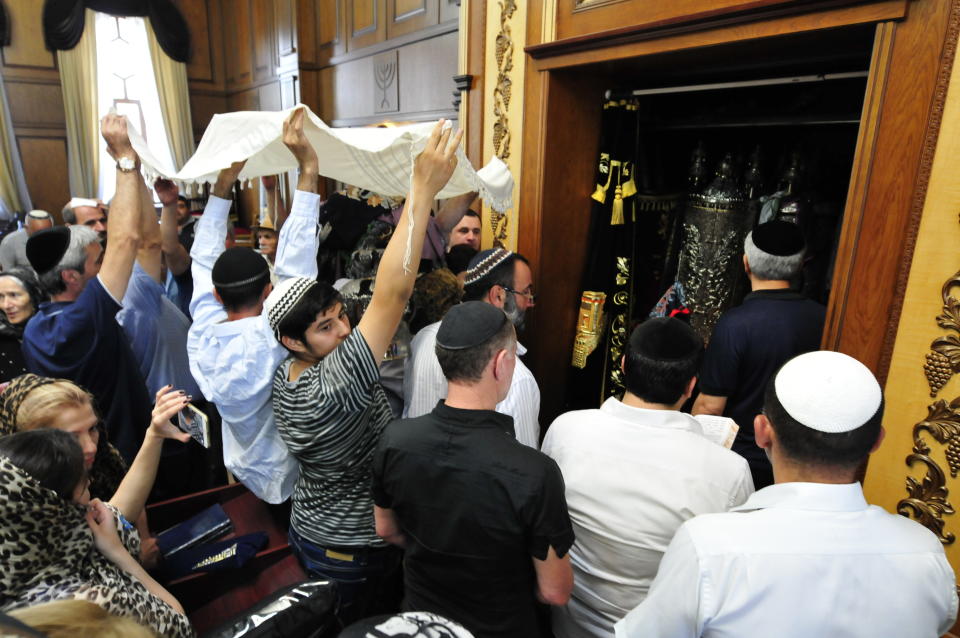 FILE - Believers participate in a service in the Kele-Numaz synagogue in Derbent, Russia, on Tuesday, Sept. 8, 2015. Jews in the predominantly Muslim region of Dagestan in southern Russia say they are determined to regroup and rebuild following a deadly attack by Islamic militants on June 23 on Christian and Jewish houses of worship in Derbent and the regional capital of Makhachkala. (Sergei Rasulov/NewsTeam via AP)