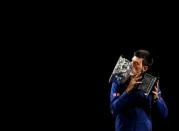 Serbia's Novak Djokovic kisses the men's singles trophy after winning his final match against Britain's Andy Murray at the Australian Open tennis tournament at Melbourne Park, Australia, January 31, 2016. REUTERS/Brandon Malone