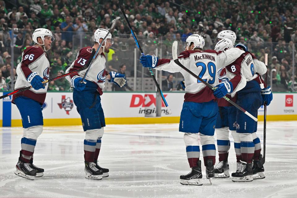 Colorado Avalanche players celebrate the game-tying goal scored by Nathan MacKinnon (29) against the Dallas Stars.
