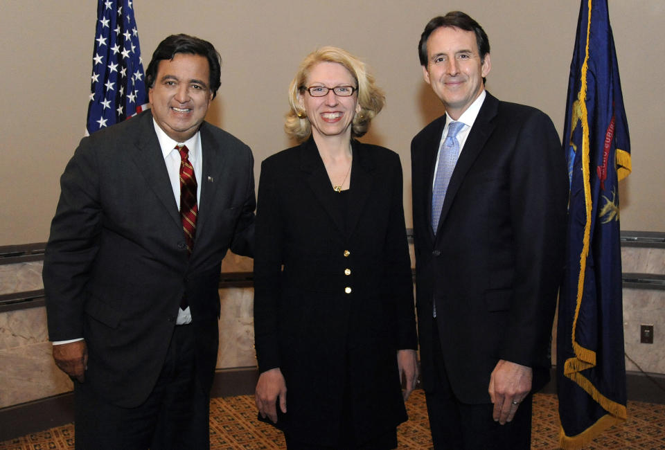 In this March 6, 2014 photo Terri Lynn Land poses with former Governor of New Mexico, Bill Richardson, left, and Tim Pawlenty, right, former governor of Minnesota, during a Michigan Political Leadership Program in Livonia, Mich. Land, a conservative Republican and former Secretary of State, is in a race with Democrat Gary Peters who is trying to broaden the Democrats’ midterm electorate by winning over some GOP voters while remaining true to the party’s shrinking urban, labor-based core. (AP Photo/Jose Juarez)