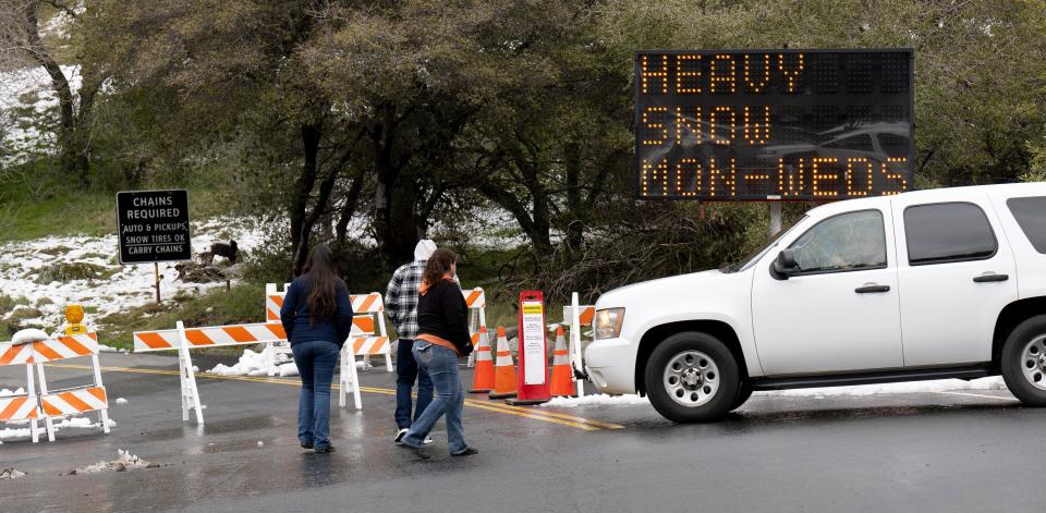 Visitors cross Generals Highway Sunday, February 26, 2023 at Hospital Rock in Sequoia National Park. The road is open six miles from the Sequoia entrance via Highway 198 and closed to traffic beyond that due to weather conditions from recent storms.