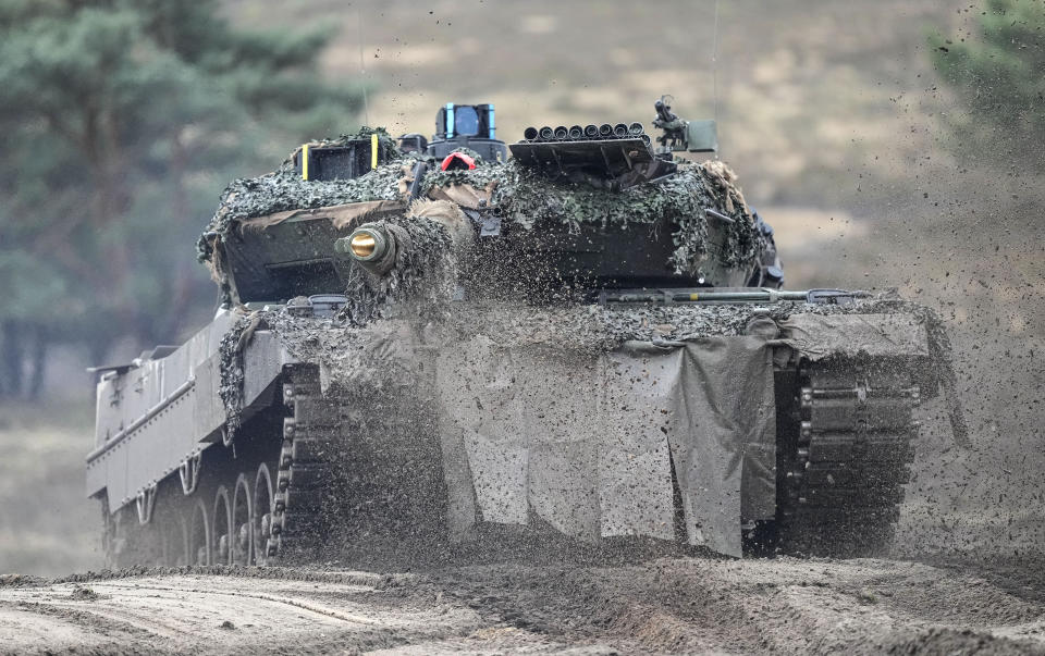 FILE -- A Leopard 2 tank is seen in action during a visit of German Defense Minister Boris Pistorius at the Bundeswehr tank battalion 203 at the Field Marshal Rommel Barracks in Augustdorf, Germany, Wednesday, Feb. 1, 2023. Nearly a year after Chancellor Olaf Scholz declared Russia’s invasion of Ukraine a 'turning point' that would trigger German weapons supplies to a country at war and a massive increase in spending on the German armed forces, his country’s military turnaround still has a long way to go. (AP Photo/Martin Meissner, file)